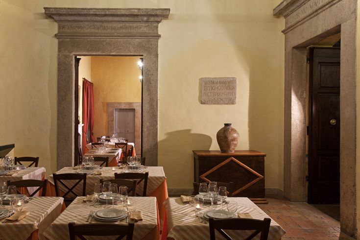 Interior of a restaurant with neatly arranged tables and rustic style decorations.