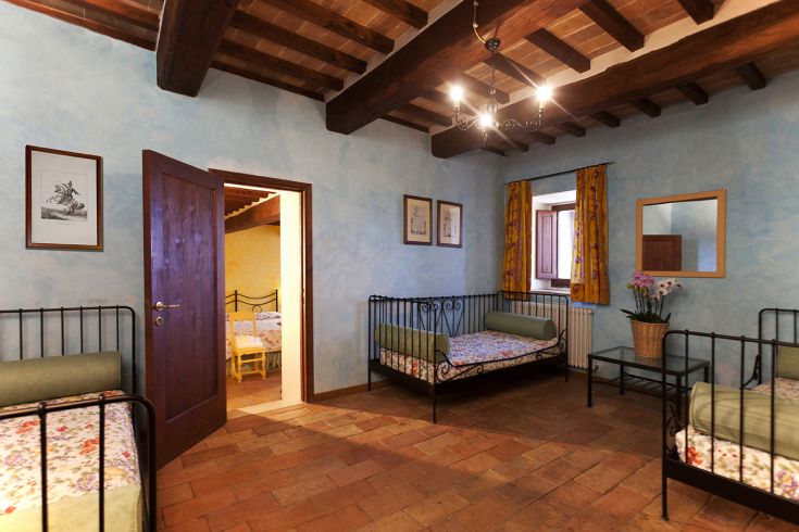 A simple room with single beds and traditional style decorations.