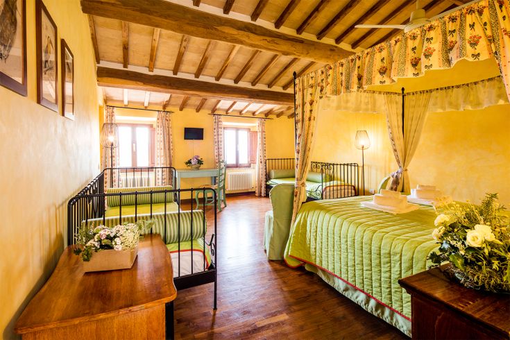 Interior of a room with canopy beds and vintage furniture.