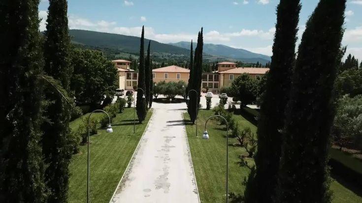 Scena del Palazzo Delfina, immerso nella vegetazione verdeggianta dell'Umbria.