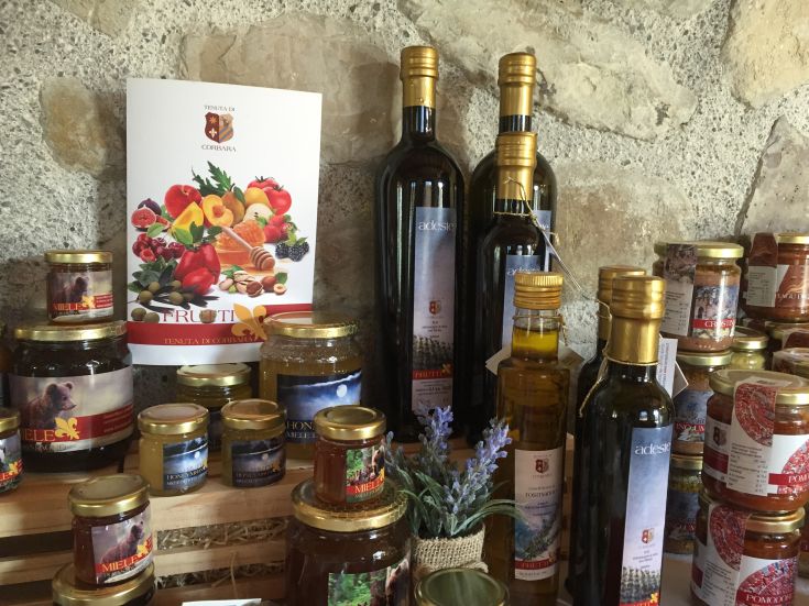 Showcase of typical products from the Corbara estate, including honey, oil, and preserves.