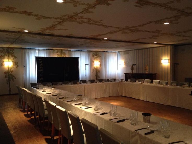 A simple event space set up with decorated tables and ready-to-use tableware.