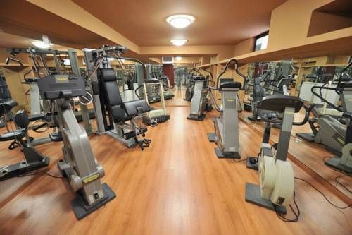 A fitness area equipped with various workout machines and training equipment.