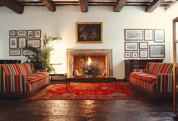 A cozy room with classic furnishings and a lit fireplace, perfect for moments of calm and comfort.