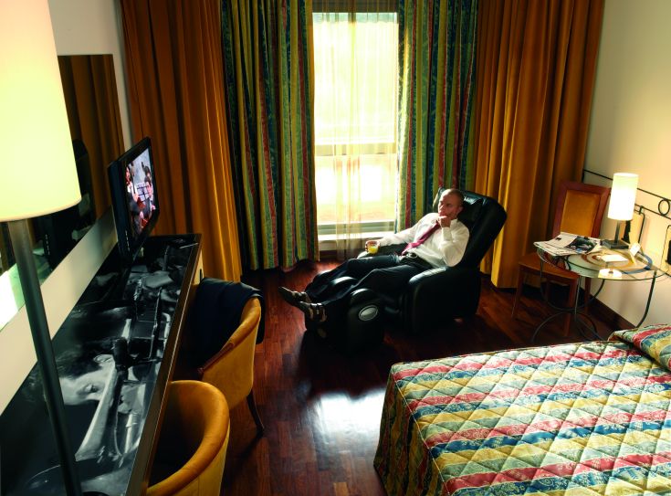 Ein einfaches Hotelzimmer, gut eingerichtet mit modernen Möbeln und beruhigenden Farben.