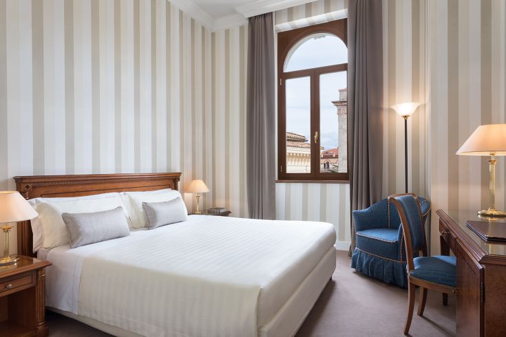 Camera accogliente con arredi sobri e panorama su Perugia, perfetta per un soggiorno rilassante.