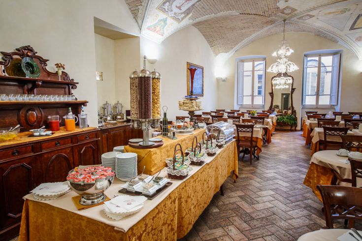 Breakfast area with a large buffet featuring decor elements of historical interest.