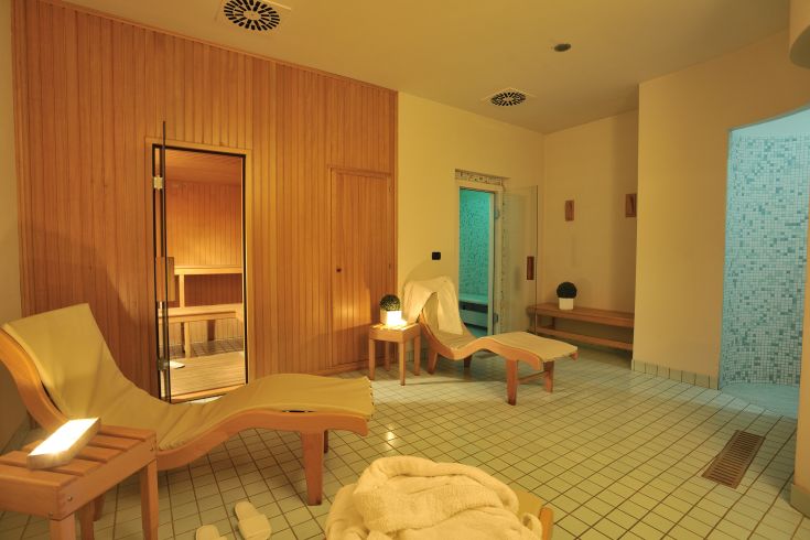 A wellness area featuring a sauna and wooden loungers, ideal for relaxation and tranquility.