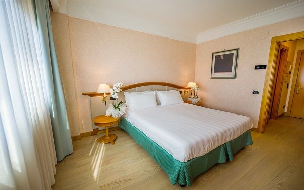 Spacious and cozy hotel room in Perugia, featuring comfortable details and simple design.