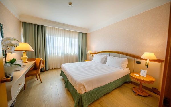 Bright double bedroom with simple and well-arranged furniture, perfect for a stay in Umbria.