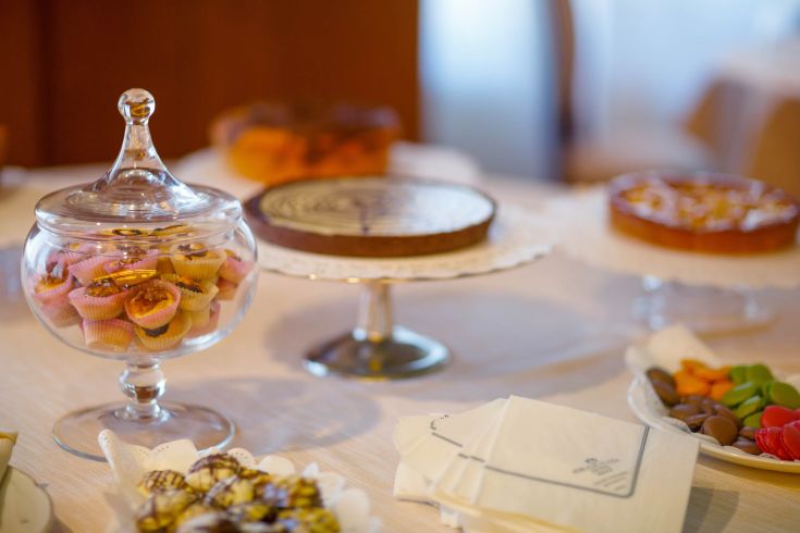 A selection of desserts and pastries arranged on a beautifully set buffet.