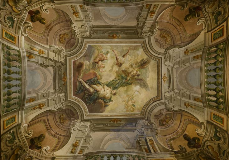 Detail of a decorated ceiling in a palace, featuring architectural and historical elements.