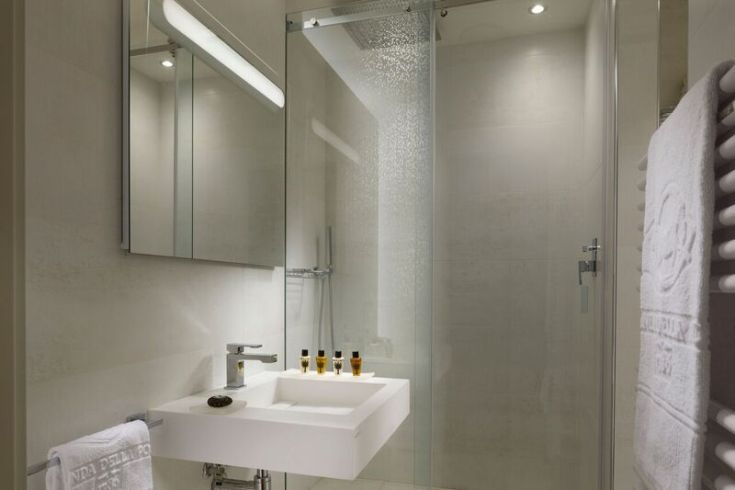 Simple bathroom with modern shower and sink, suitable for daily use.