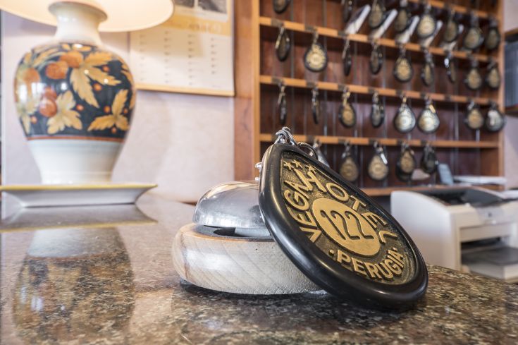 A simple hotel located between Assisi and Gubbio, featuring well-furnished rooms and an outdoor pool surrounded by greenery.