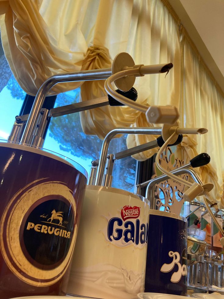 Various chocolate dispensers filled with creamy delights in our cozy hotel.