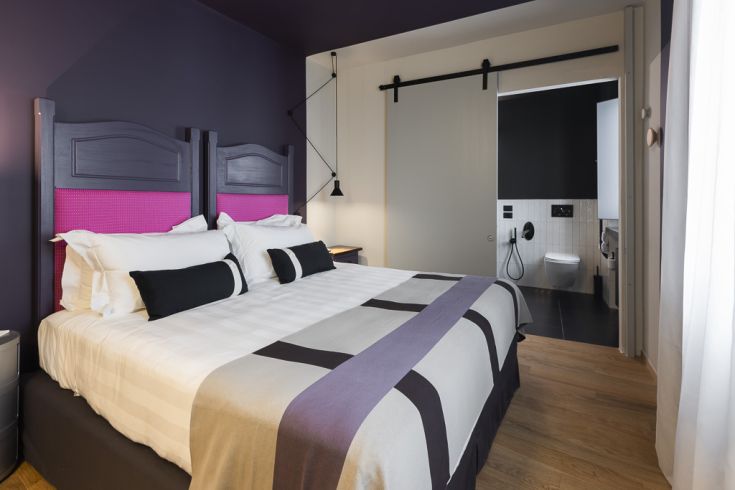 Camera semplice con letti matrimoniali, dotata di bagno privato.