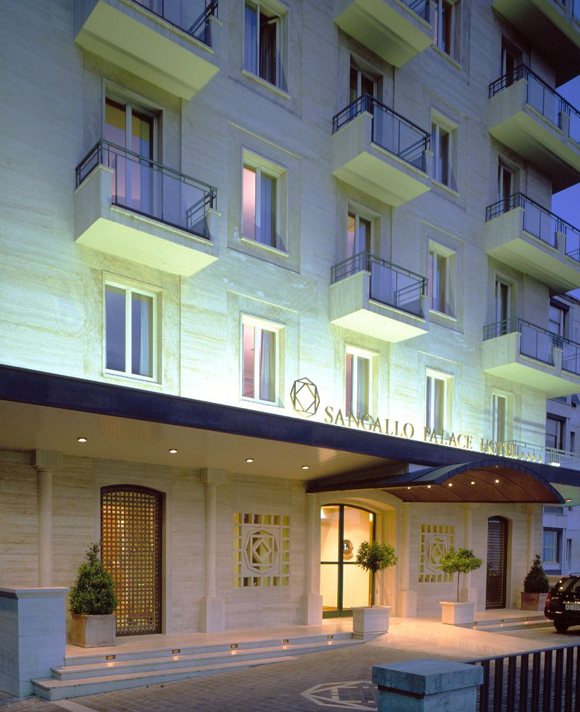 Facade of Palazzo Sangallo, featuring a simple design in a relaxed urban setting.