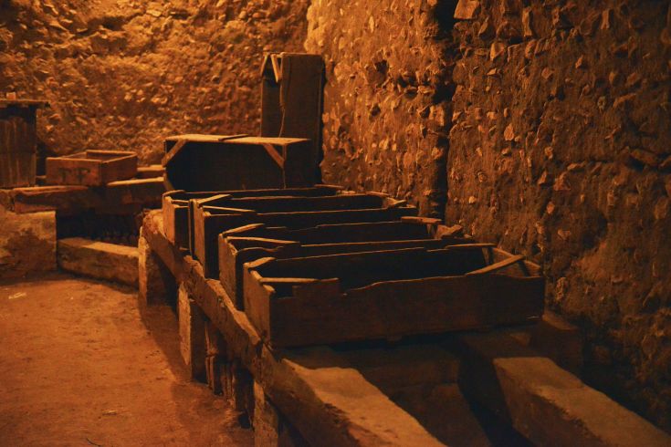 Interior of a palace with wooden shelves, illuminated by soft and welcoming light.