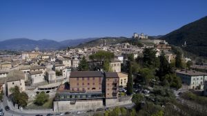 Scene of an ancient village nestled among gentle green hills, offering a tranquil atmosphere.