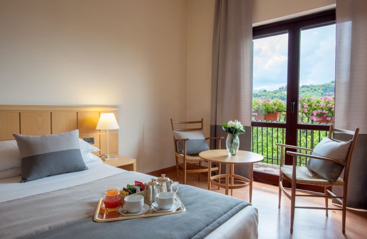 Cozy hotel room featuring simple, welcoming decor, perfect for a relaxing stay.