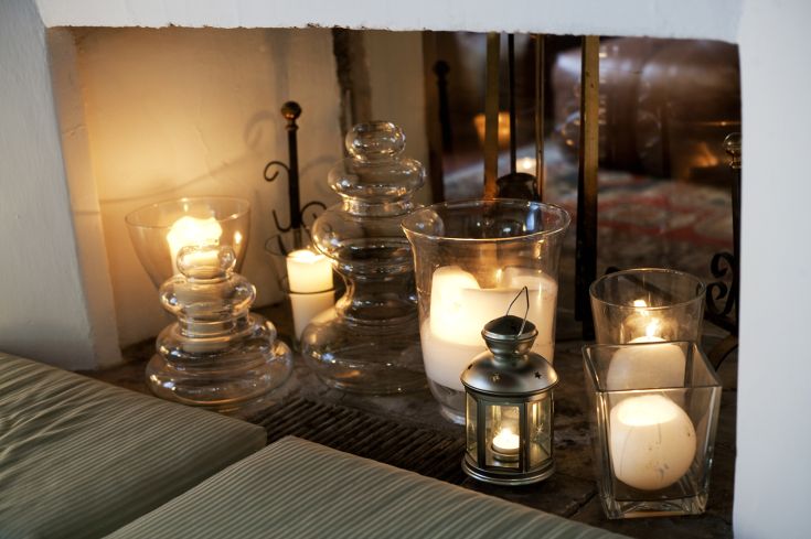 A cozy corner with candles and simple decorations creating a soft lighting ambiance.