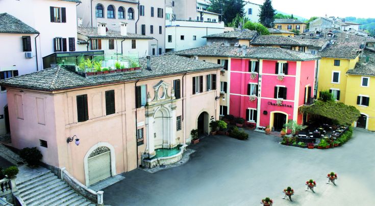 Detail of a hotel located in the historic center of Spoleto, showing the building's facade with characteristic architectural elements.