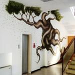 A mural depicting a tree in street art style, featuring good natural lighting.