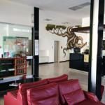 Entrance of the Arca Hotel, featuring wall decorations and practical furnishings.