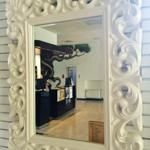 A simple mirror that reflects a tidy and cozy atmosphere.