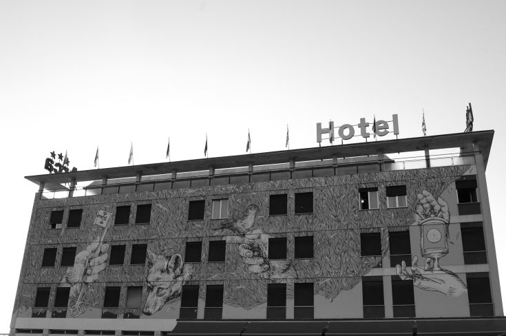 Colorful mural on the building's facade creates a welcoming atmosphere with simple, vibrant details.