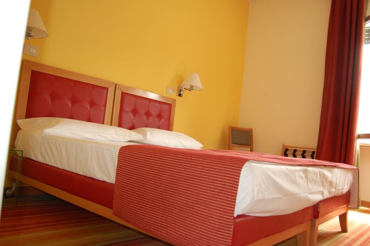 Cozy bedroom with double beds, perfect for a relaxing stay.