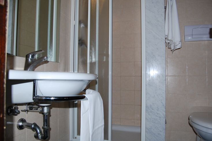 Cozy bathroom furnished with sink, shower, and sanitary fixtures in a simple, practical space.