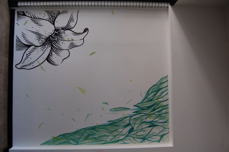 A mural depicting a flower on an abstract background with varied and captivating hues.