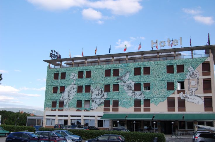 A building adorned with a contemporary mural, creating a welcoming atmosphere.