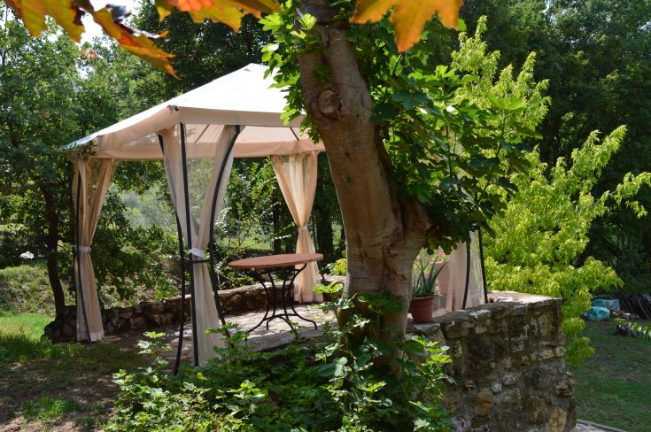 A gazebo surrounded by trees, perfect for peaceful moments in nature.