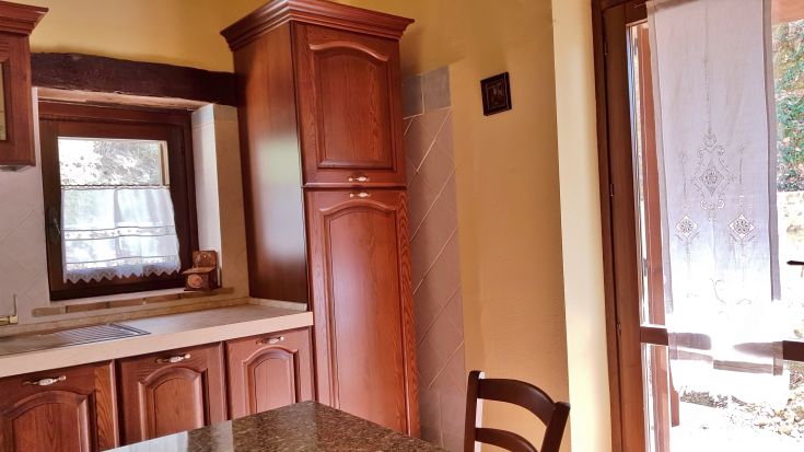 Bright and simple kitchen at the agriturismo Tra Cielo e Terra, featuring wooden elements.