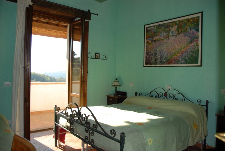 Cozy and well-lit room with simple decor. A welcoming retreat in Umbria.