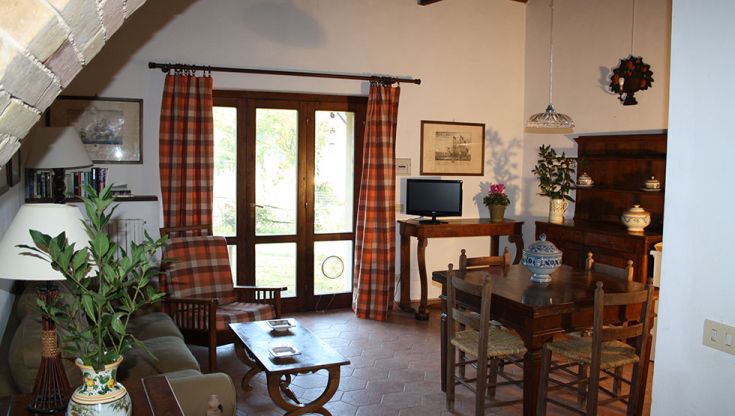 Cozy wooden and brick living room with a view of the garden. Peaceful and comfortable atmosphere.