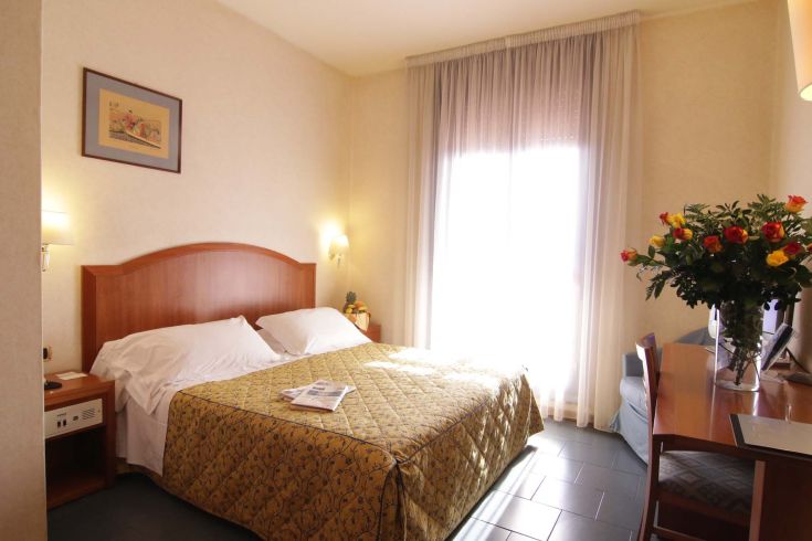 Serene hotel room with natural light, ideal for a peaceful and comfortable stay.