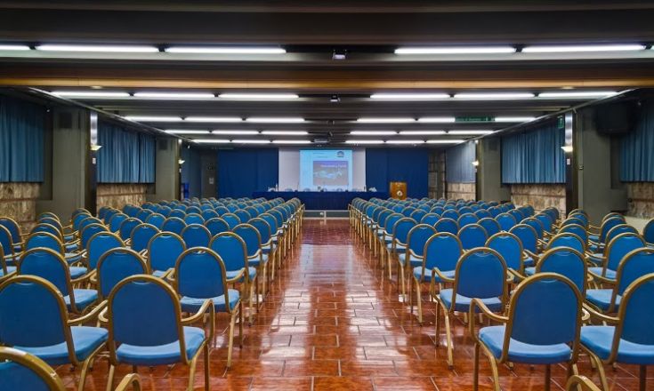 Spacious conference room with various seating arrangements, ideal for meetings or training events.