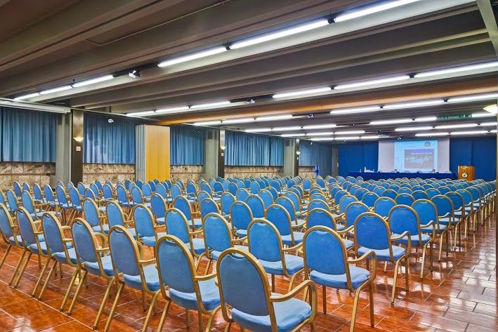 A spacious conference room inside a hotel, suitable for meetings and presentations.