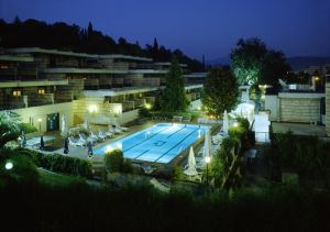Evening shot of the Garden Hotel, featuring a lit pool that creates a relaxed atmosphere.