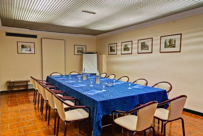 Meeting room setup with a long table and comfortable furnishings.