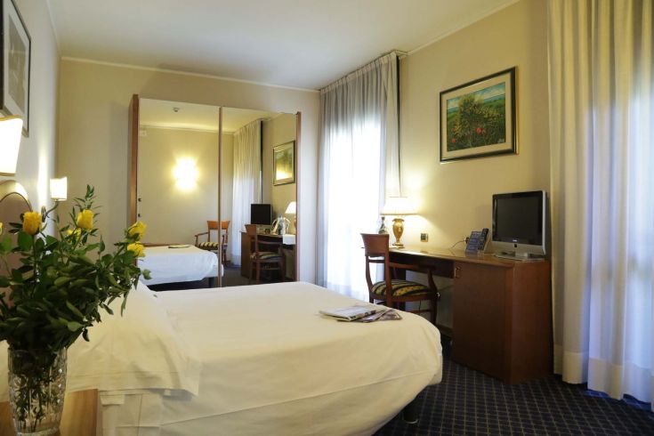 Room at the Garden Hotel in Umbria, simple and well-maintained, perfect for a relaxing stay.