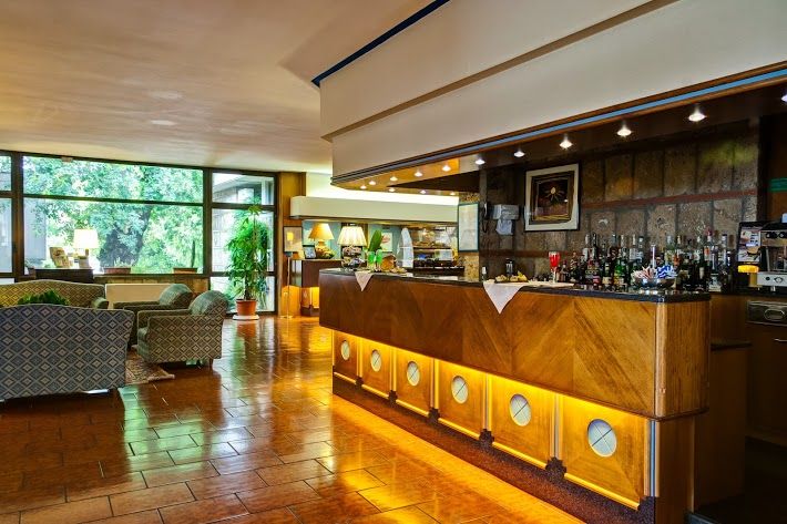 The lobby of the Garden Hotel, a bright and welcoming area to relax and meet others. Simple and functional decor.