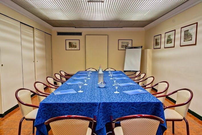 Meeting room space with a blue table and chairs, ideal for various meetings and events.