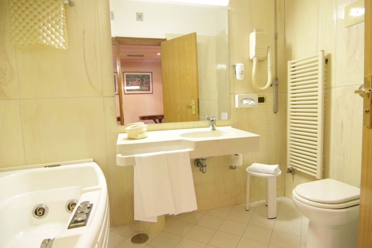 A contemporary bathroom featuring a bathtub, sink, and toilet. Bright and well-organized space.