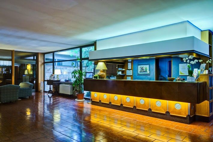 Simple and welcoming reception of the Garden Hotel, providing hospitality to guests.