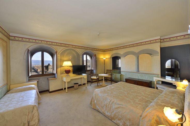 Comfortable hotel room in a historic building with panoramic views of Todi.