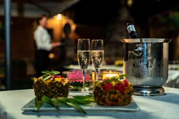 A beautifully set table with champagne and fresh fruit, creating a cozy atmosphere for special moments.